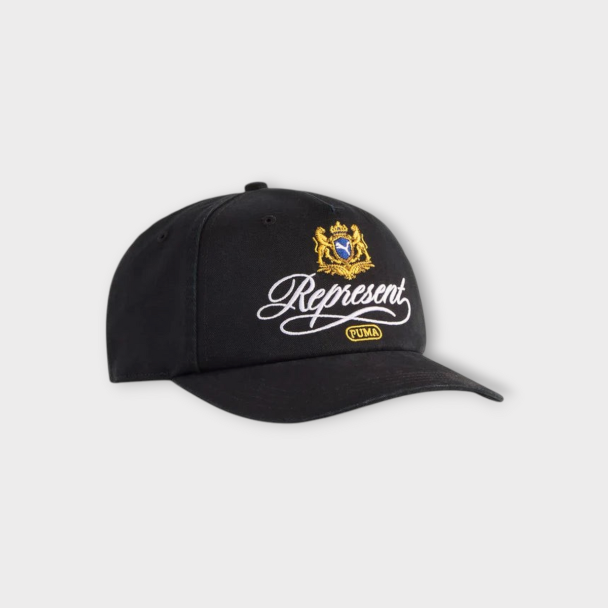 Drop PUMA x REPRESENT black baseball cap featuring an embroidered gold crest and white cursive logo on the front.