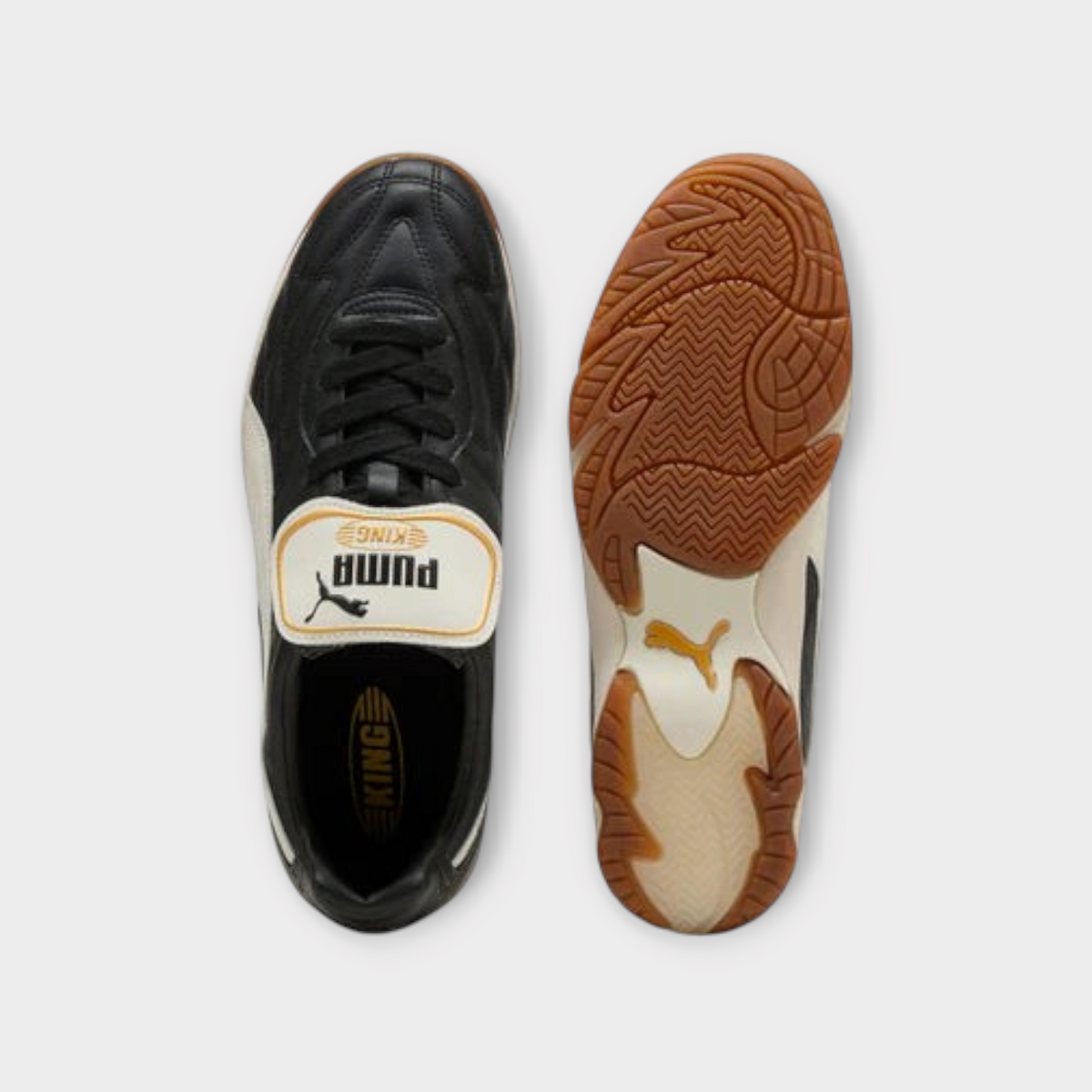 Drop Puma King indoor sneakers in black and warm white with gum rubber outsoles, top and bottom view