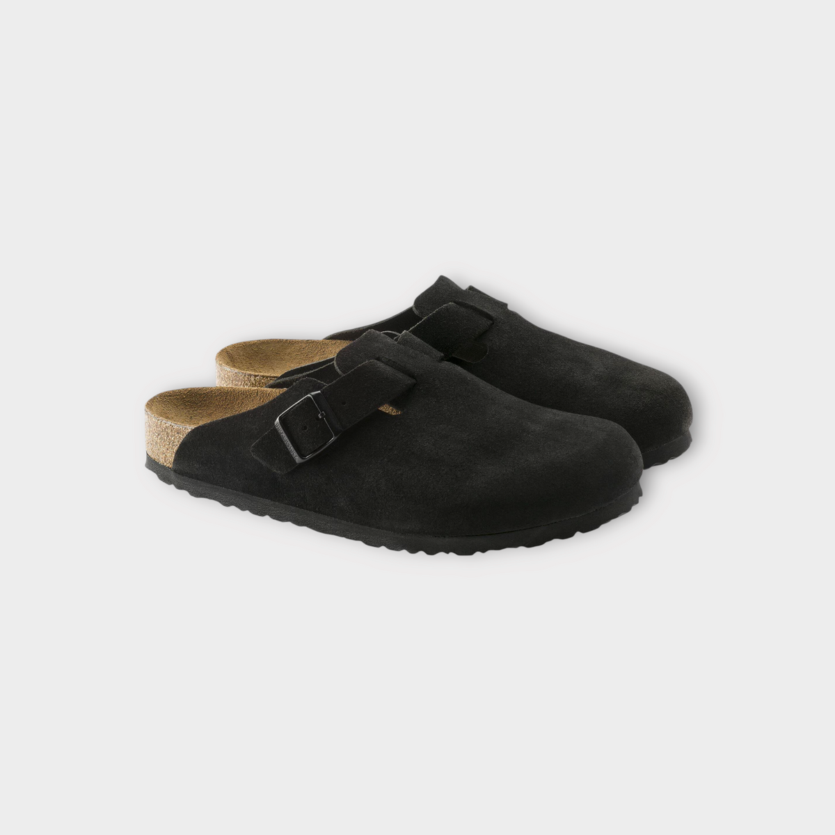Drop Birkenstock Boston clogs in black suede with a cork footbed and adjustable buckle strap