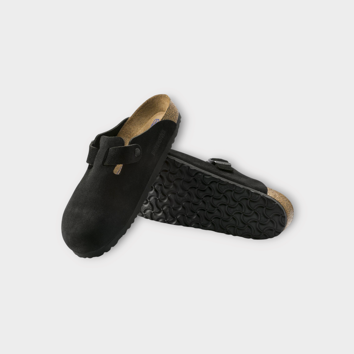 Drop Birkenstock Boston clogs in black suede with signature cork footbed and adjustable strap