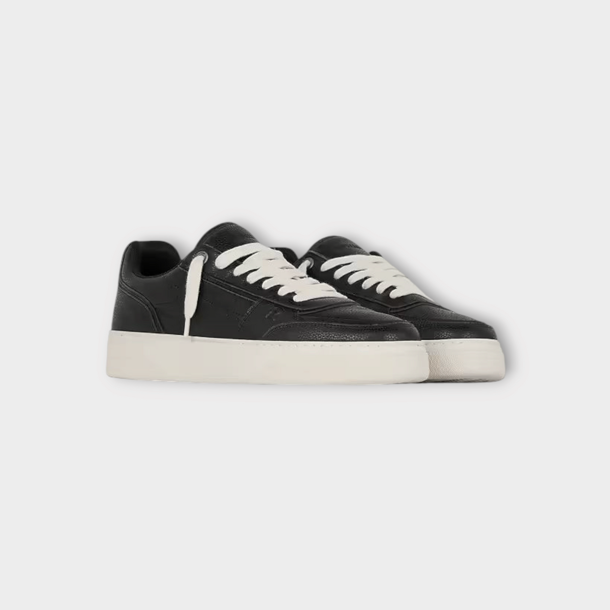 Drop Represent Initial black leather sneakers with white laces and a thick white rubber sole.