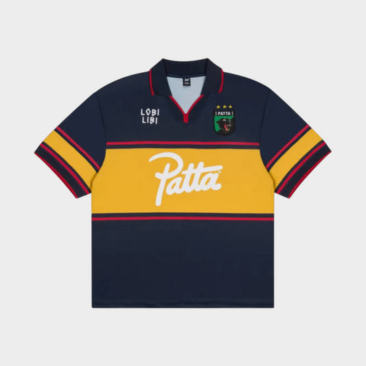 Drop Patta Legacy football jersey in Parisian Night navy blue with a yellow chest stripe and white logo branding.