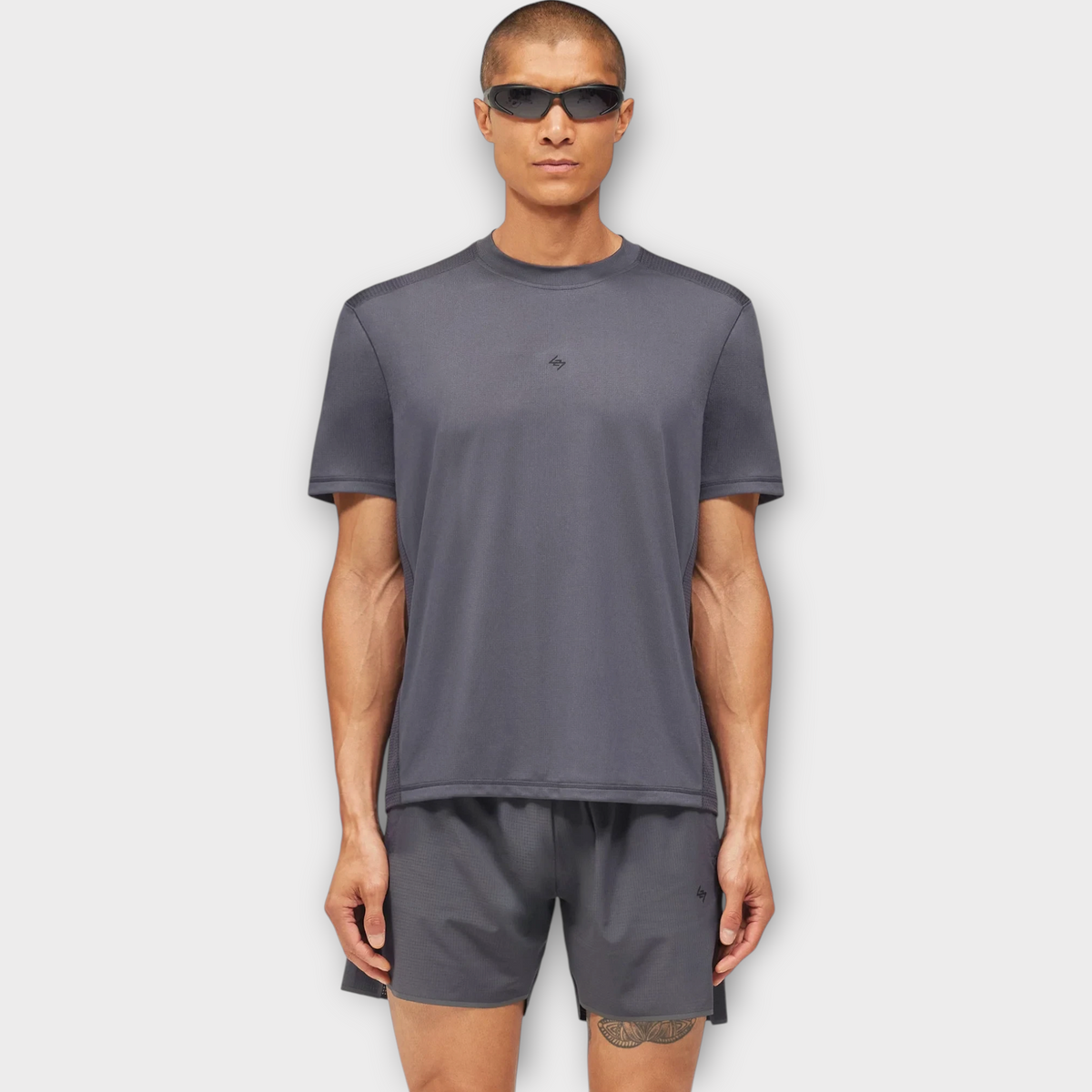 Model wearing a Drop 247 FW26 Numbers T-shirt in graphene grey with a crew neck and subtle logo detail