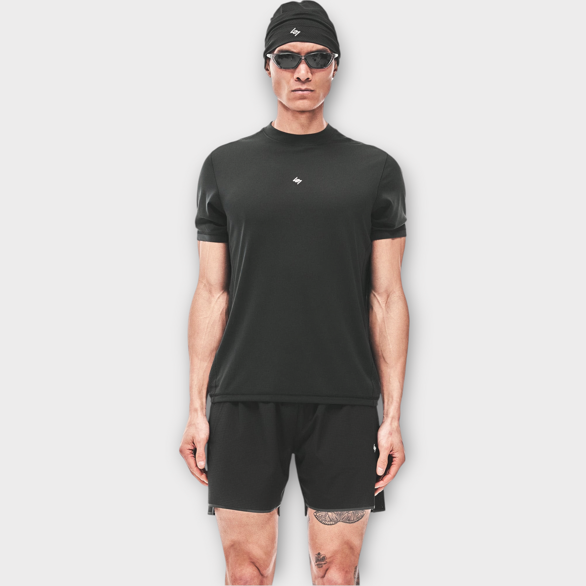Drop 247 FW26 Numbers T-shirt in jet black worn by a model with a matching black beanie and sunglasses