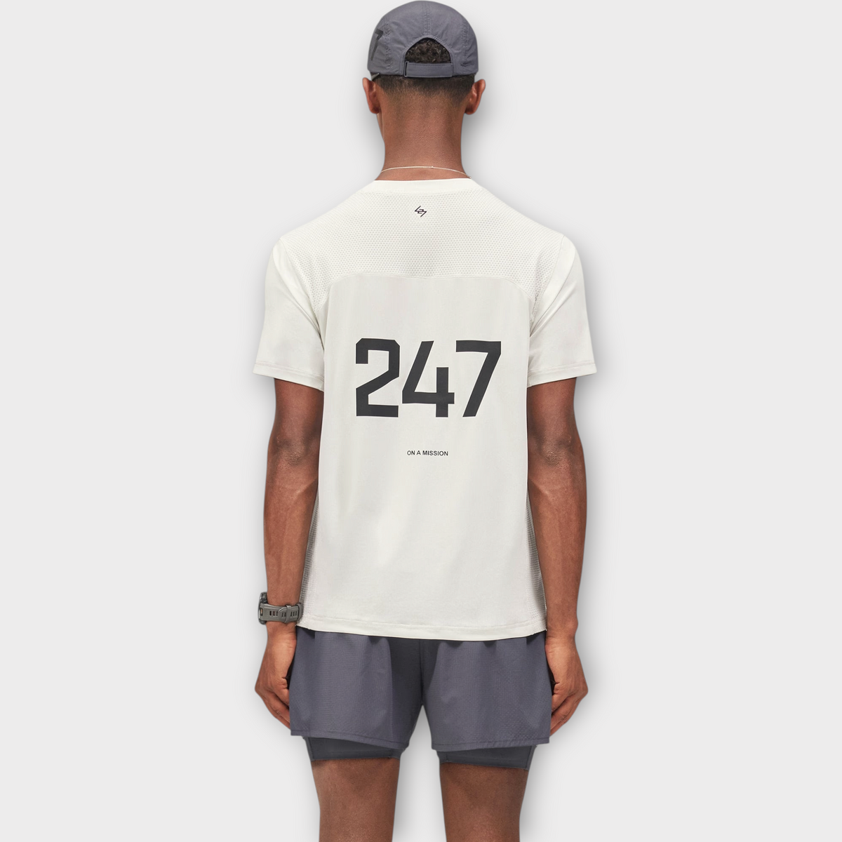 Drop 247 FW26 Numbers T-shirt in flat white with black back graphic, worn by a model from the back view