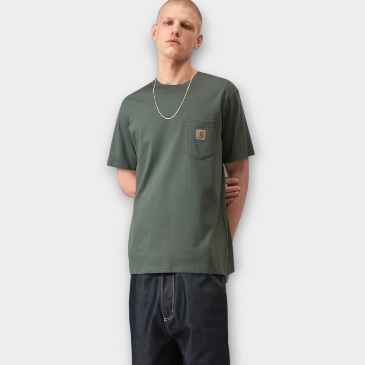 Model wearing a Drop Carhartt WIP smoke green cotton jersey t-shirt with a chest pocket and logo patch