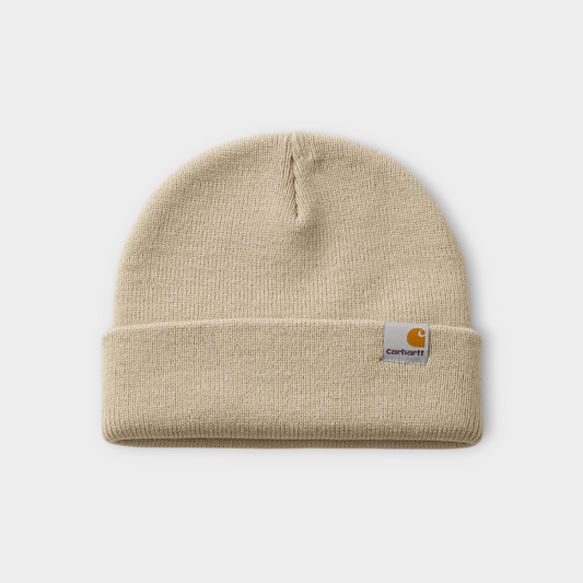 Drop Carhartt WIP Stratus Hat in low wall beige with a ribbed knit texture and a square logo patch on the cuff.