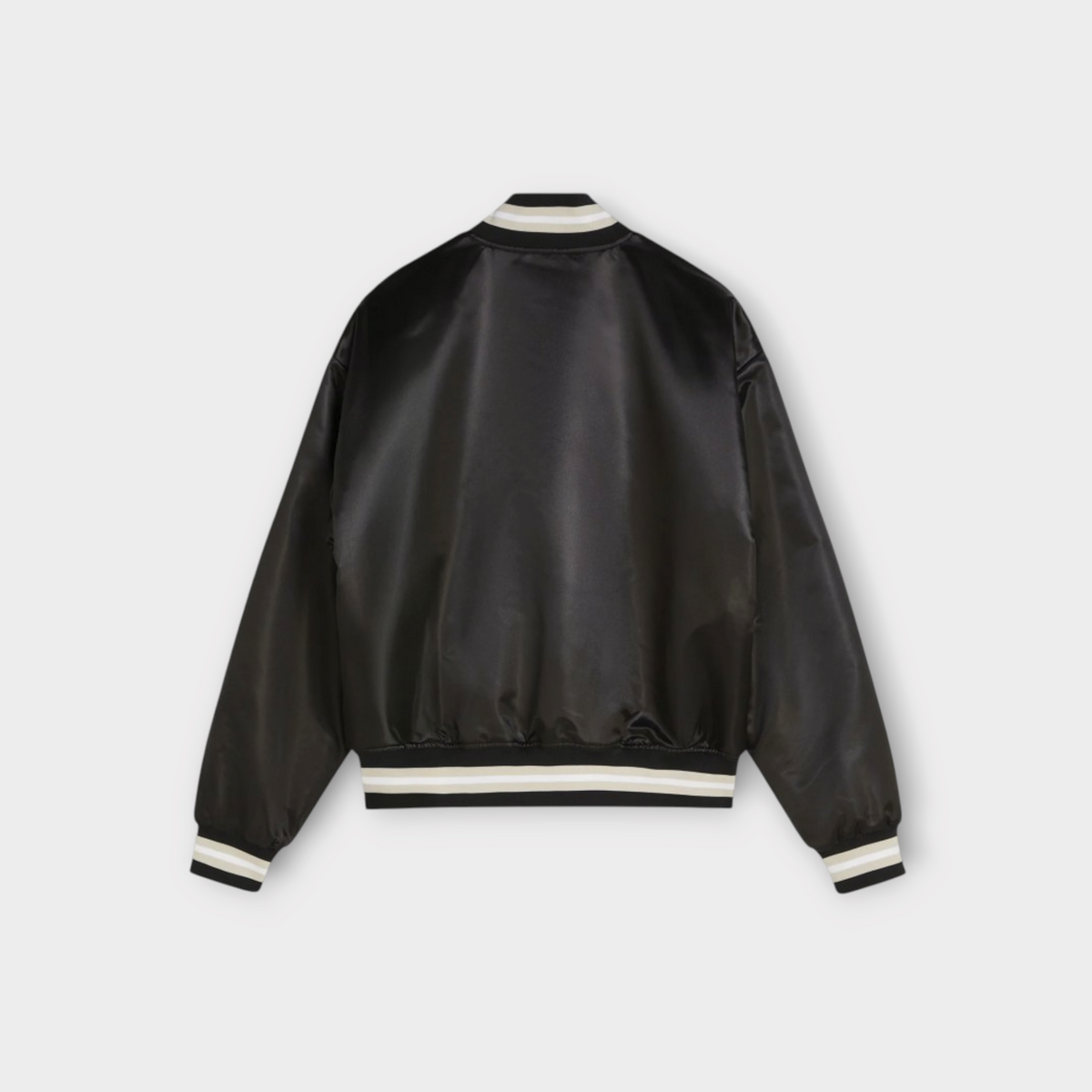 Back view of Drop Patta black satin varsity jacket with striped ribbed collar, cuffs, and hem.