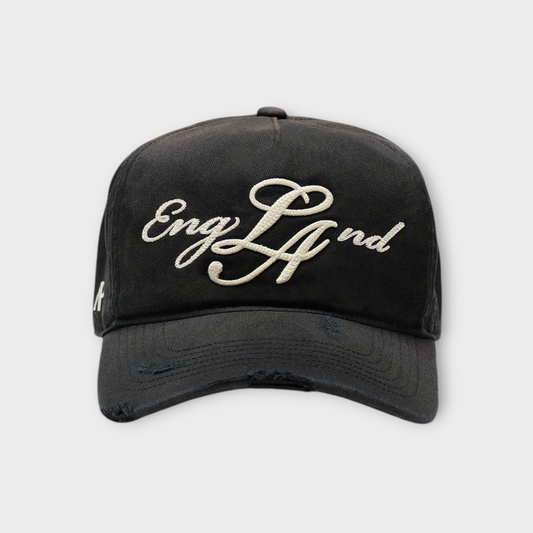 Drop Represent LA ENGLAND cap in aged black with distressed brim and white cursive embroidery