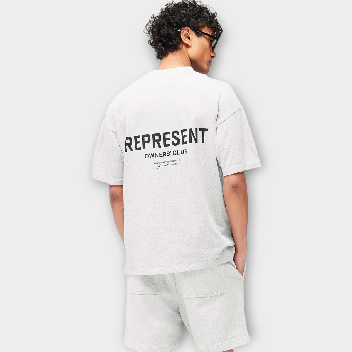 Drop Represent Owners Club t-shirt in ash grey with black back graphic logo worn by a man from behind