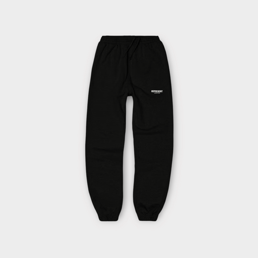Drop Represent Owners Club black sweatpants with a white logo print on the thigh and elasticated cuffs.
